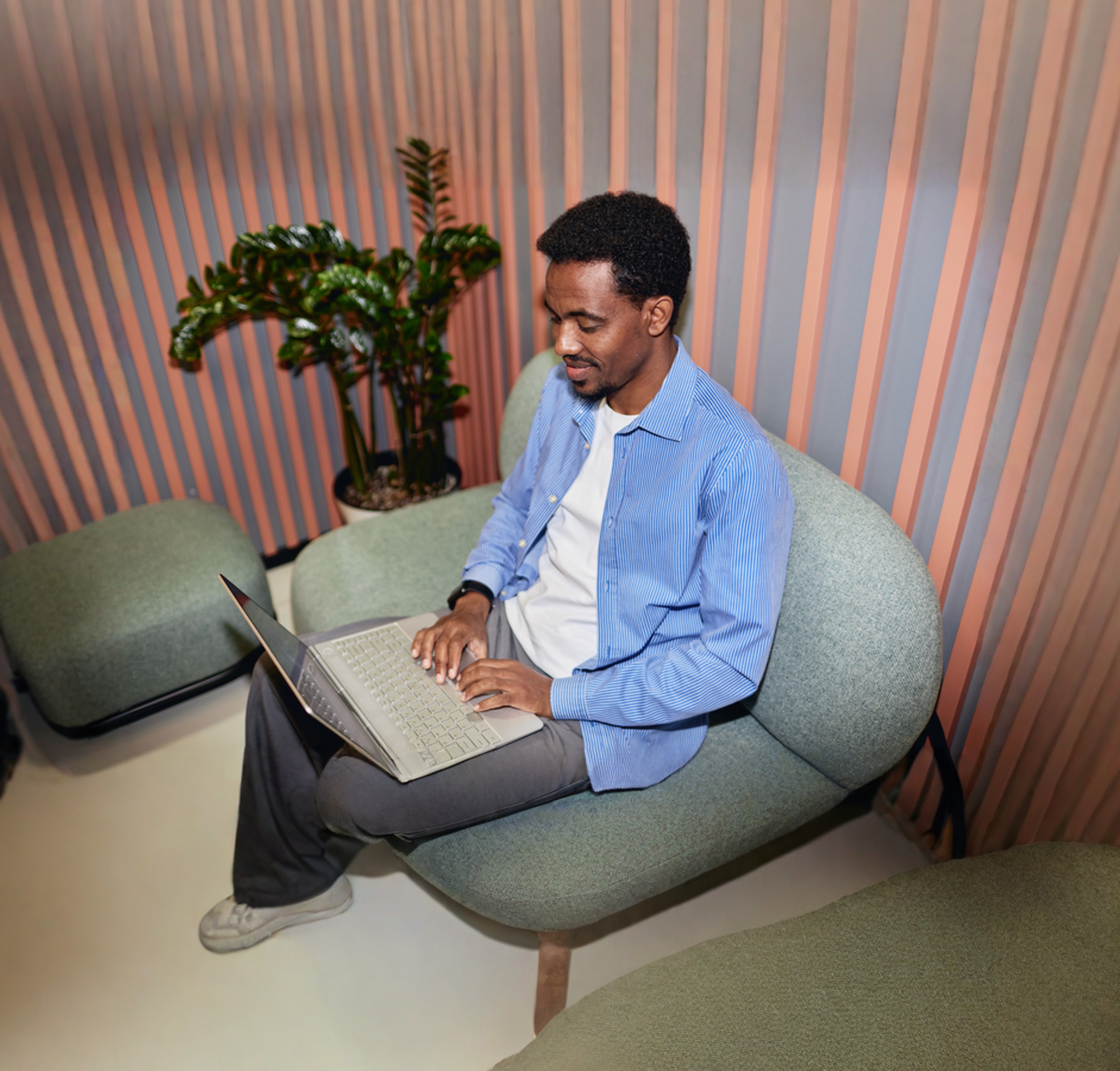 Person working on a laptop in a relaxed seating area